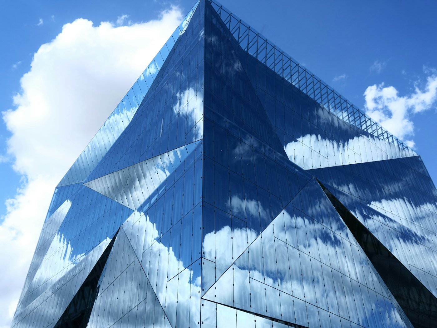 Placeholder stock photo: reflective tinted glass building against a blue sky