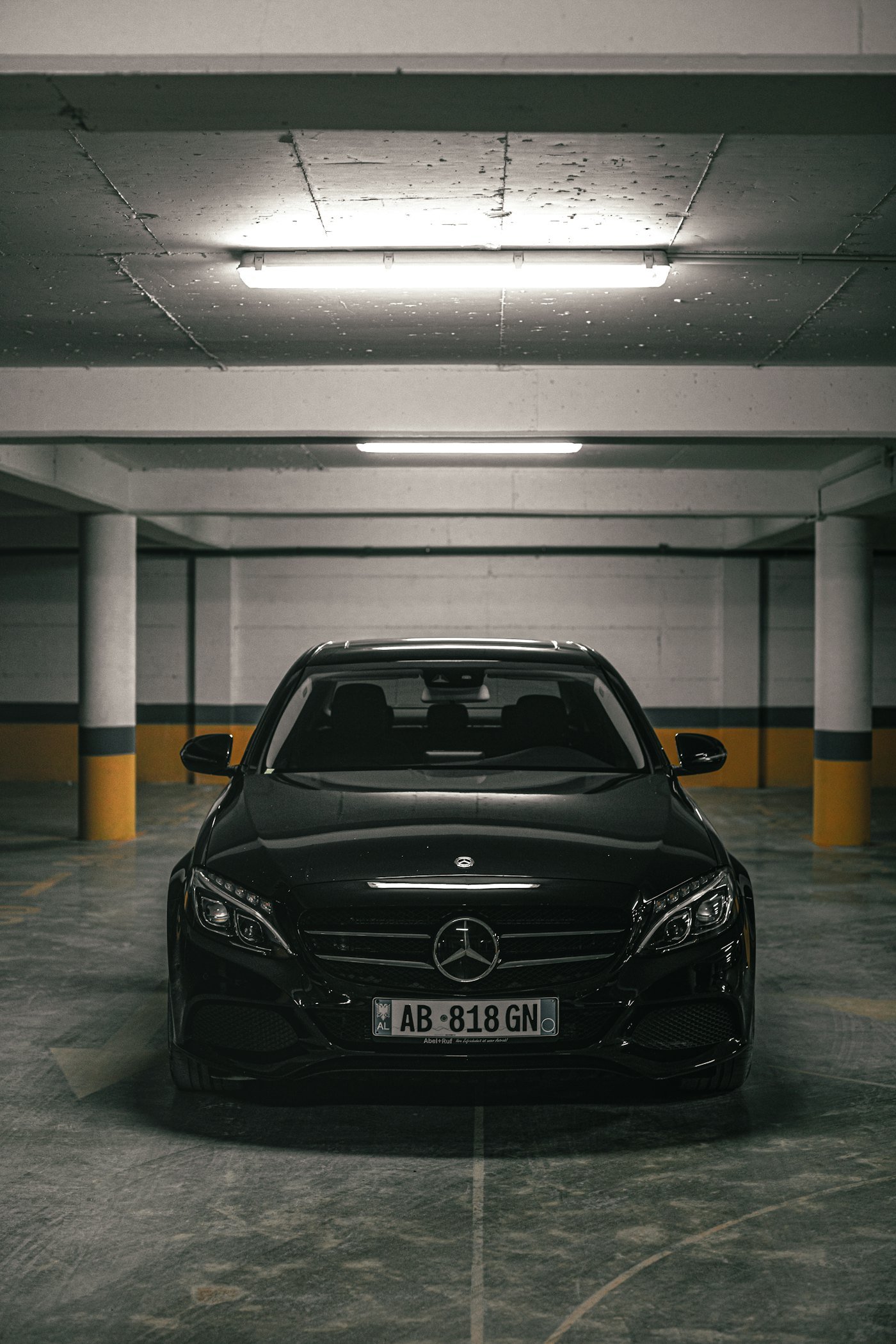 Placeholder stock photo: clean black sedan parked in a garage