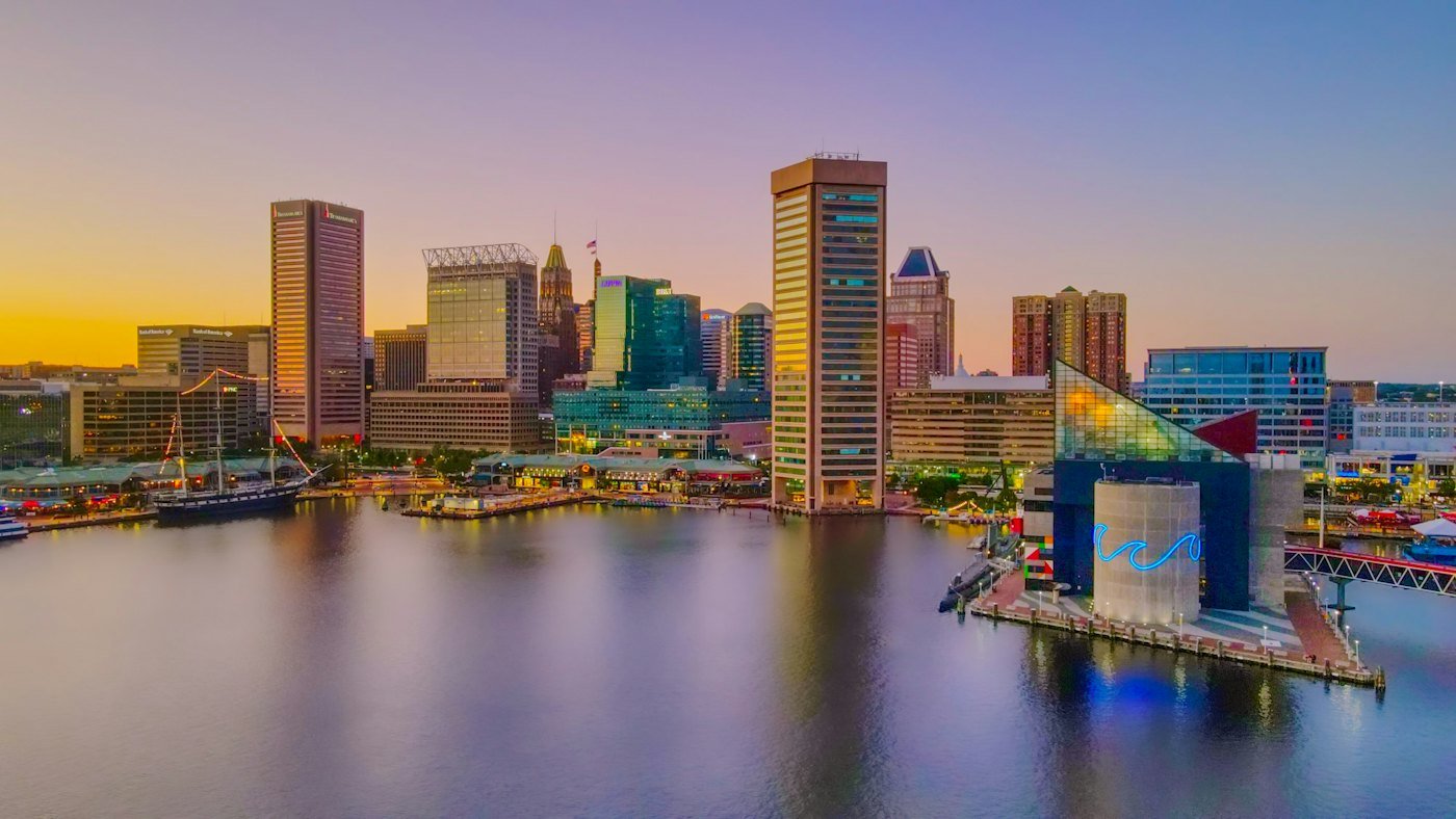 Baltimore Inner Harbor skyline reflected in the water at sunset