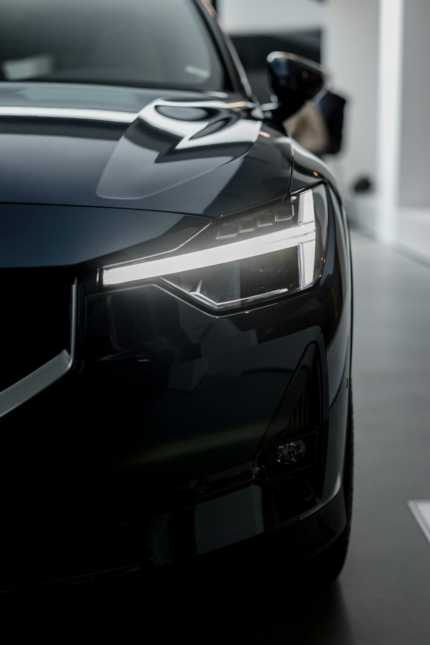 Placeholder stock photo: black car with dark tinted windows in a garage